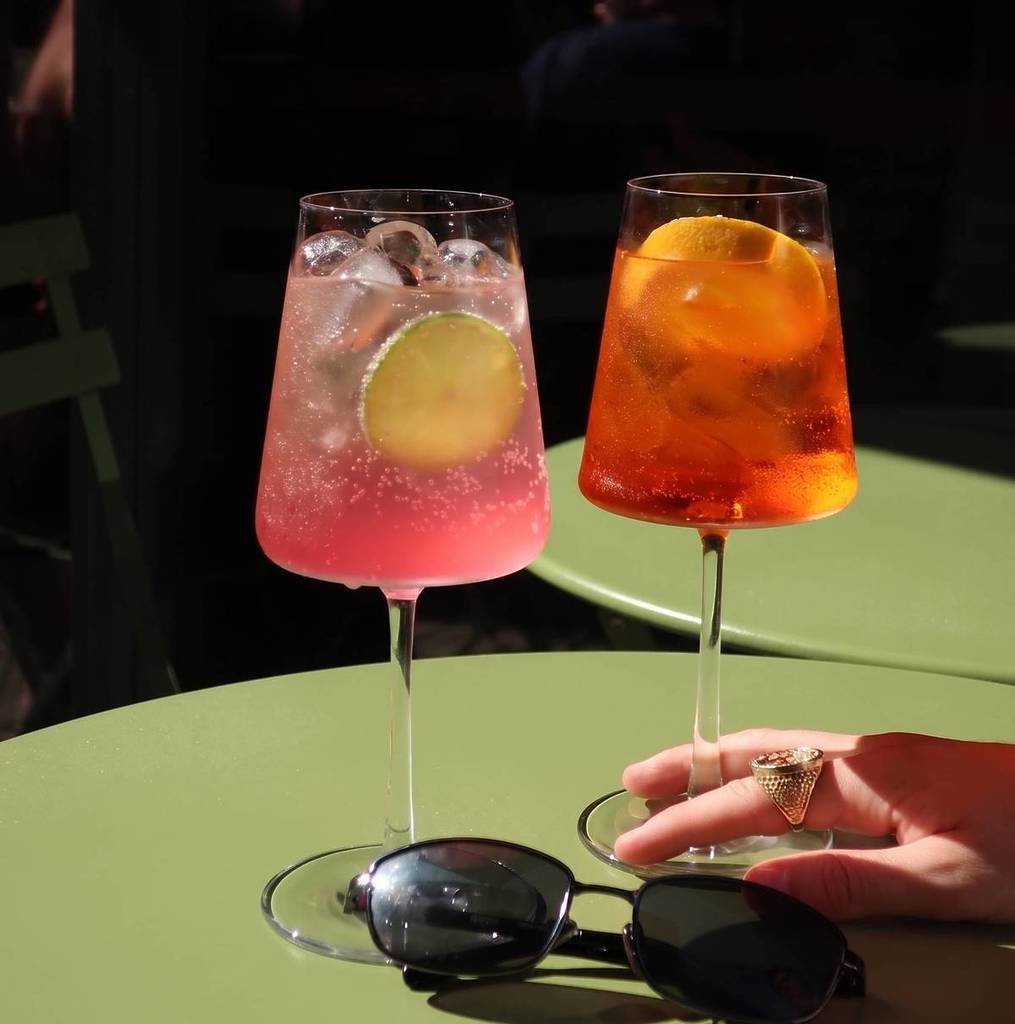 2 aperol cocktails on a green garden table