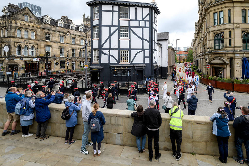 manchester salford whit walks bank holiday crowds watching procession