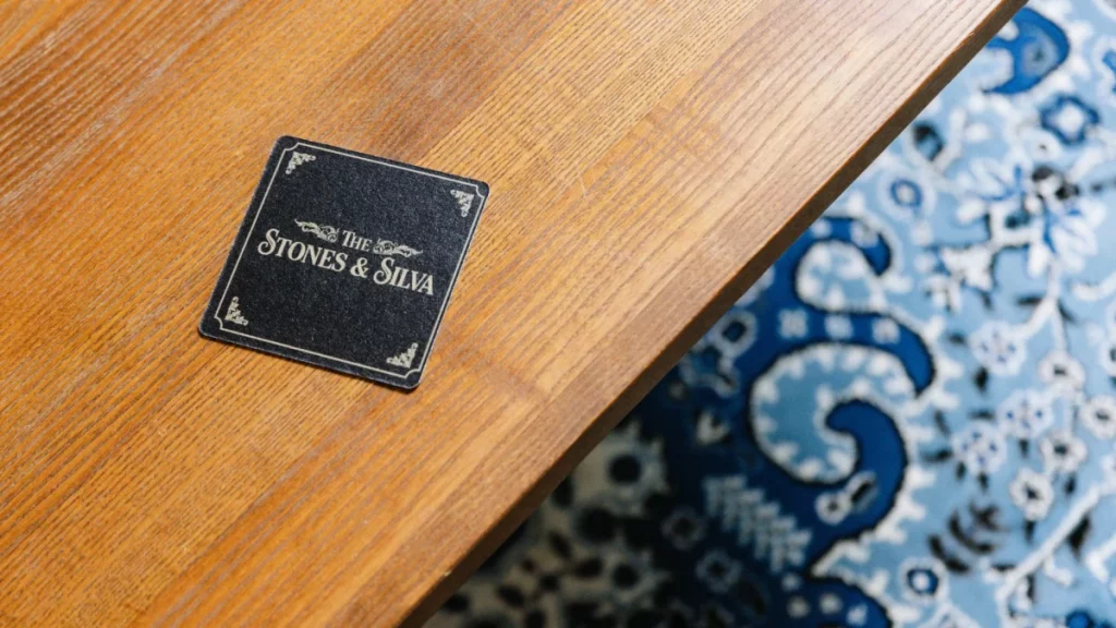 the stones and silva beer mat on table