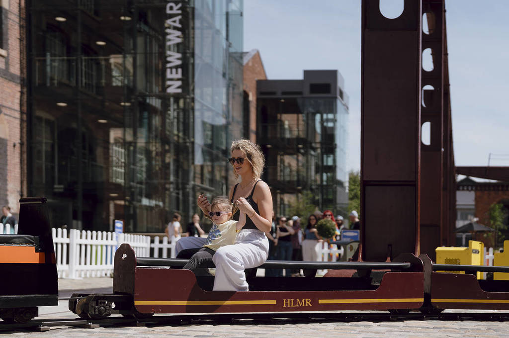 woman and child sat on mini steam train