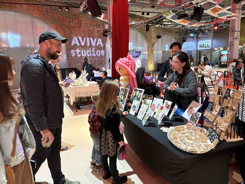 people stood at stall inside aviva studios in manchester