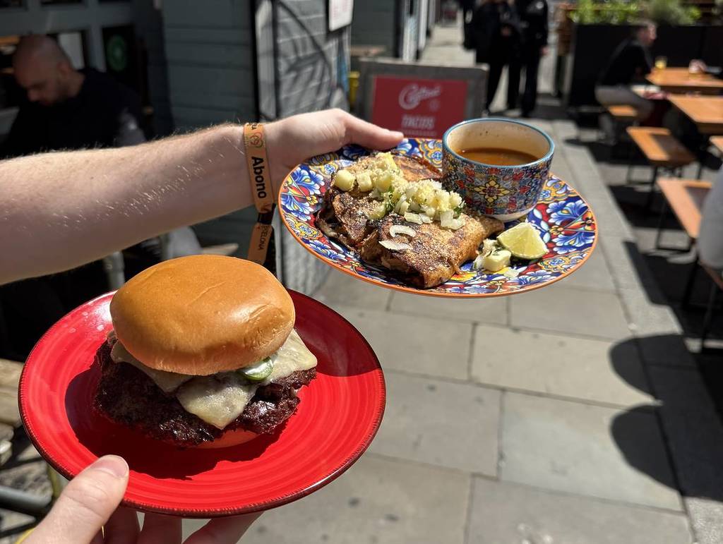 smash burgers and tacos on plates at cantina, cane and grain manchester