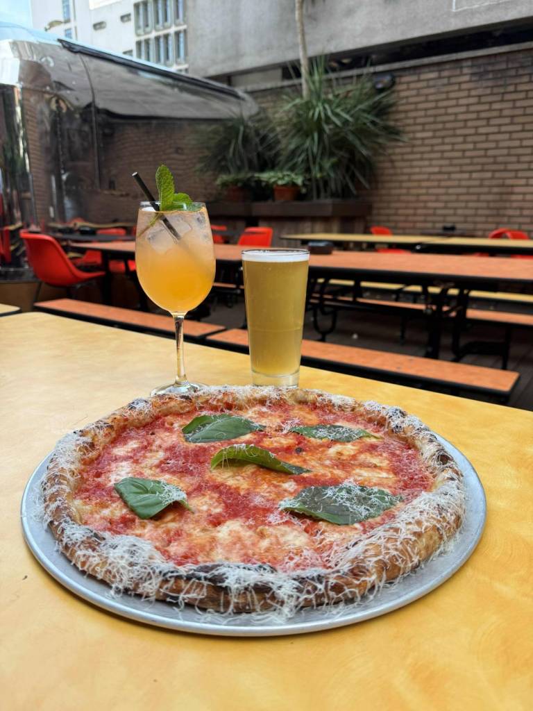 pizza, spritz and beer on table at tangerine beer garden