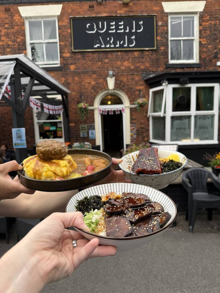 selection of japanese dishes held outside the queen's arms pub in eccles, greater manchester