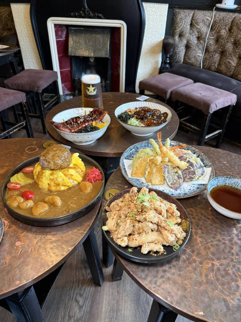 selection of japanese dishes including waygu burger with omelette and curry sauce, tempura prawns and eel rice bowls