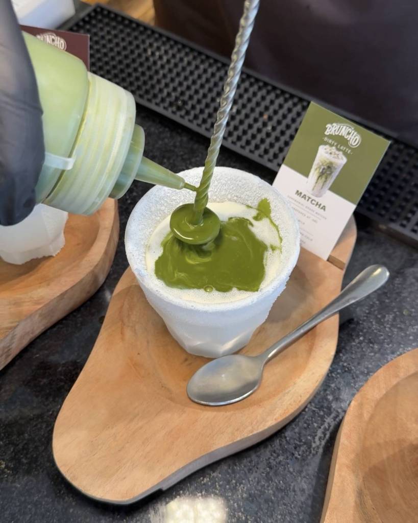 matcha being poured over milk in frozen cup at bruncho