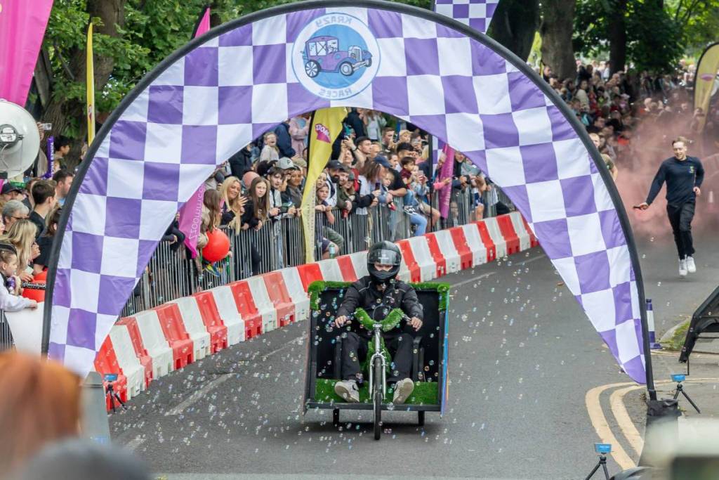 green soapbox going downhill with streams of bubbles