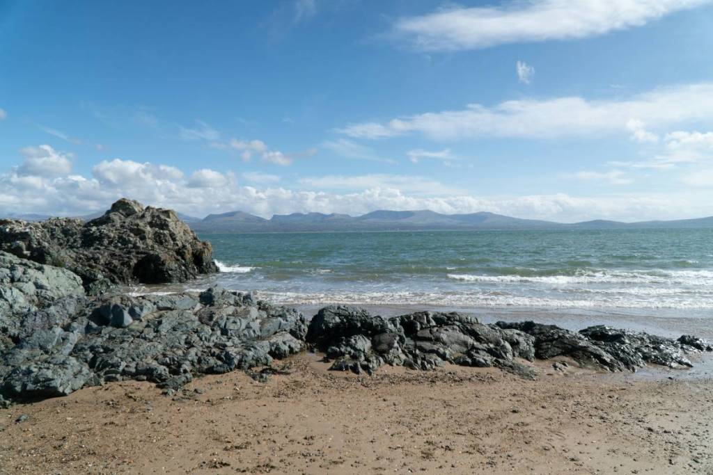tide at newborough beach, anglesey, wales