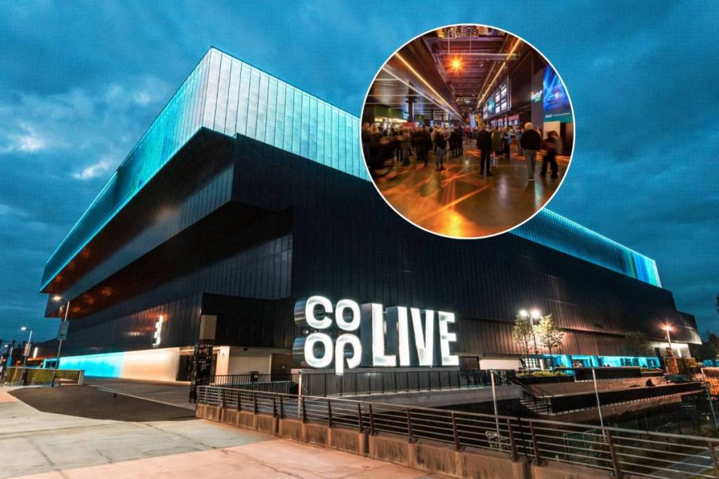co-op live exterior at night with crowd stood in front of big screen at vertu place inside arena in circle
