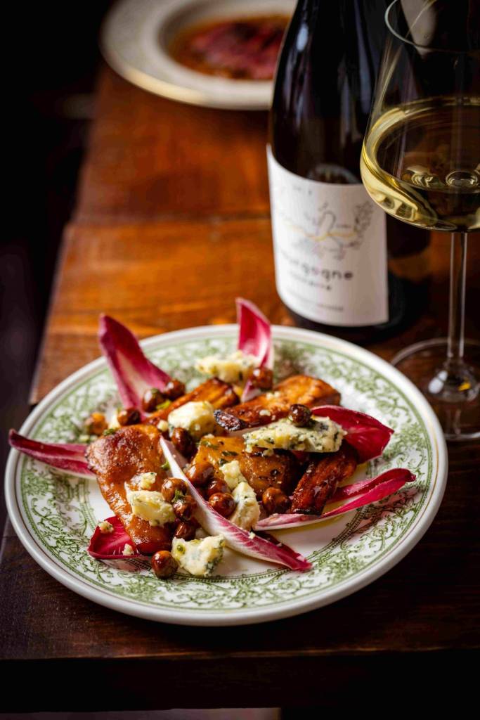 chicory salad and bottle of wine