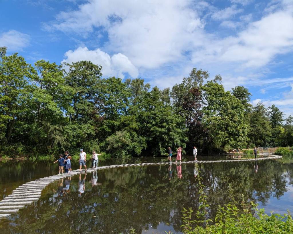 people walking across stepping stones at WWT Martin Mere, Burscough, Lancashire