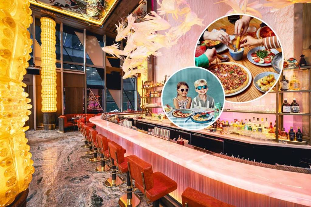 bar area inside sexy fish manchester with kids sat at table at zizzi in one circle and hands grabbing selection of food from bella italia in another circle