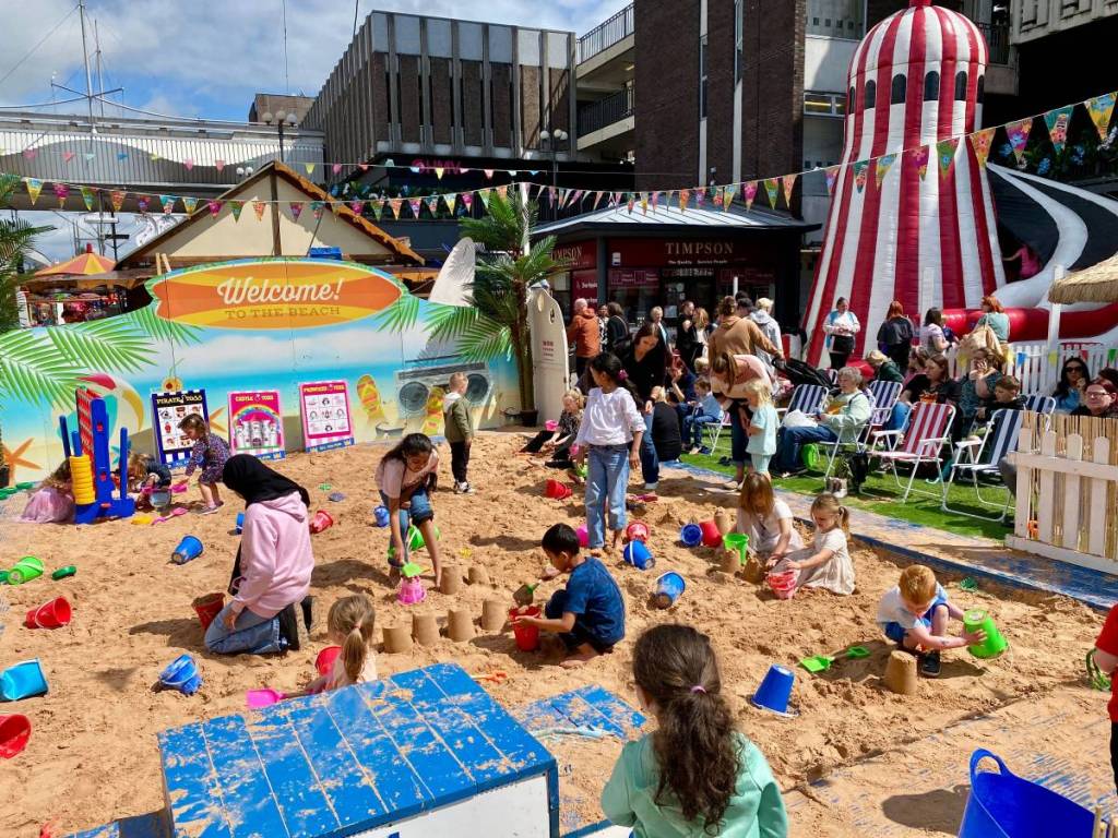 A giant free beach with golden sand, deckchairs and superhero takeovers has opened in this Greater Manchester town for the summer holidays