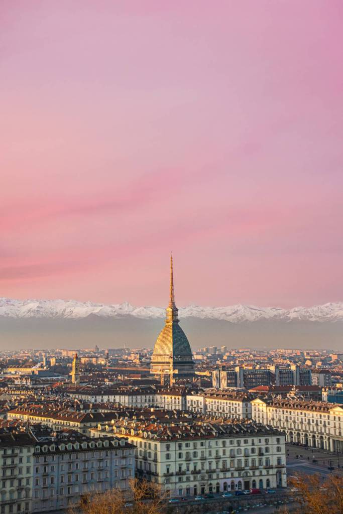 turin skyline at sunset with pink sky - one of the ski destinations that jet2.com will fly to from manchester airport