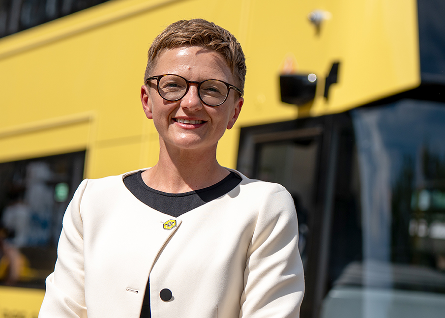 Mayor Bev Craig stood in front of yellow bee network bus outside Bolton Town Hall