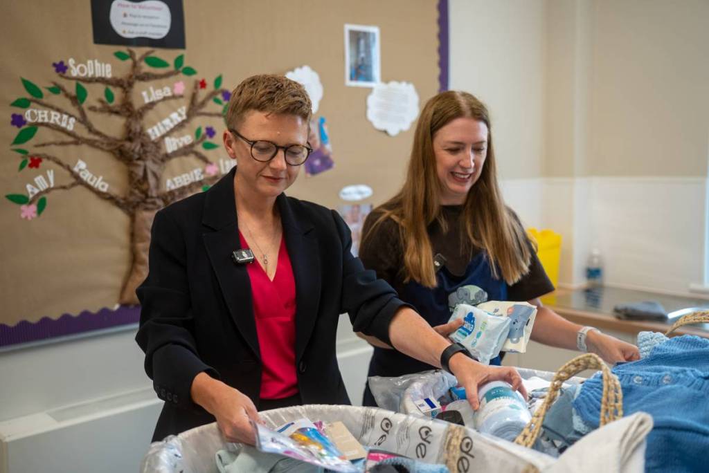 Mayor Bev Craig and Alison Wakefield with one of the baby bundles at the Leigh Family Hub