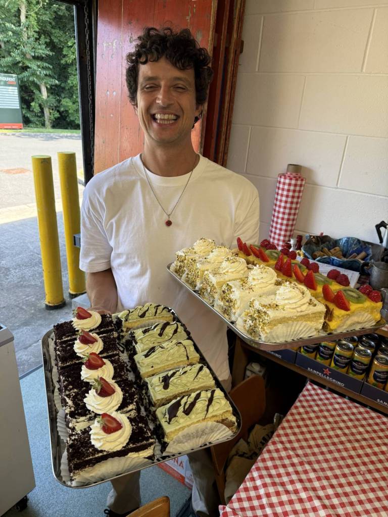 nico of lupo in prestwich holding cakes and pastries