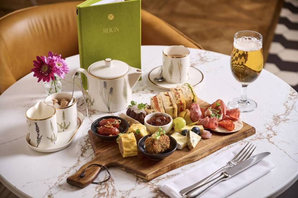 the rex savoury afternoon tea with pot of tea and charcuterie board with cold meats, cheeses, chutneys and sausage rolls