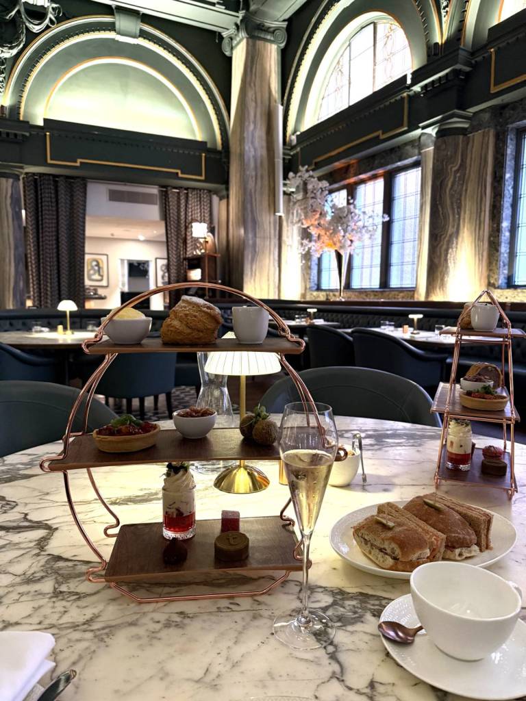 afternoon tea tiers and champagne inside tender restaurant at stock exchange hotel manchester