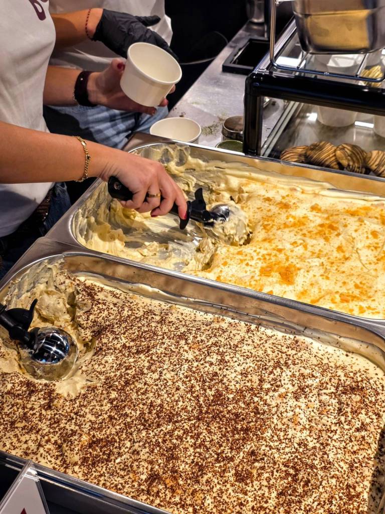 banana pudding being scooped from tray