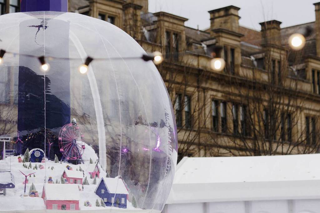 skate manchester ice rink with giant snow globe in centre with manchester cathedral gardens in background