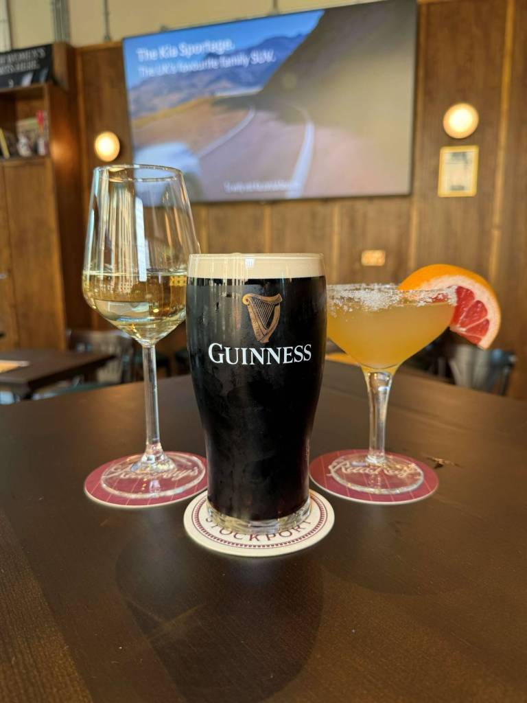 glass of wine, pint of guinness and margarita on table
