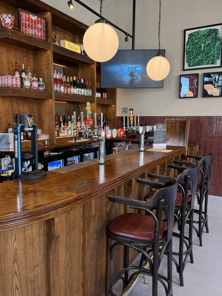 stools lined up at bar at rita ray's