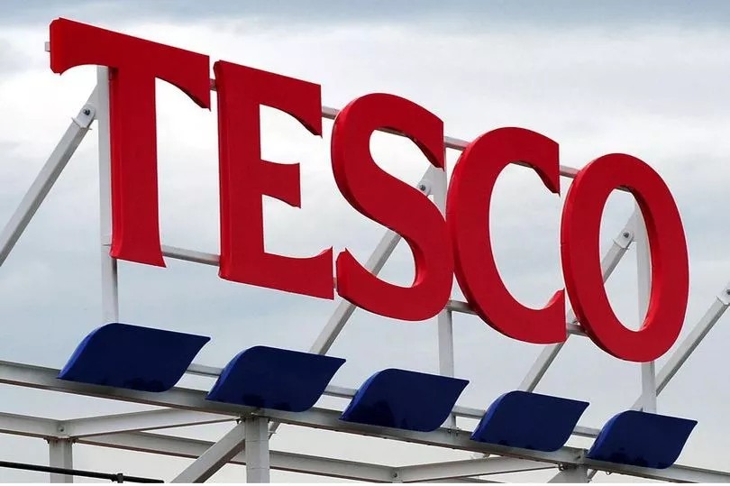 tesco logo on top of a store