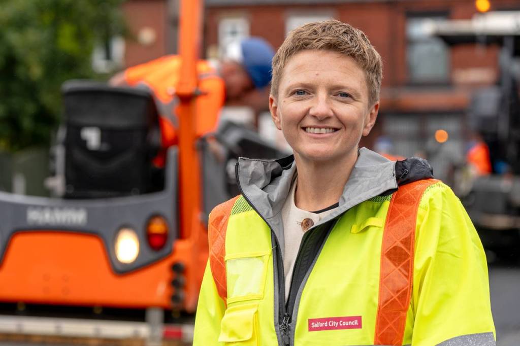 Bev Craig, Mayor of Greater Manchester in high vis jacket next road resurfacing work on Trevor Road, Eccles, Salford