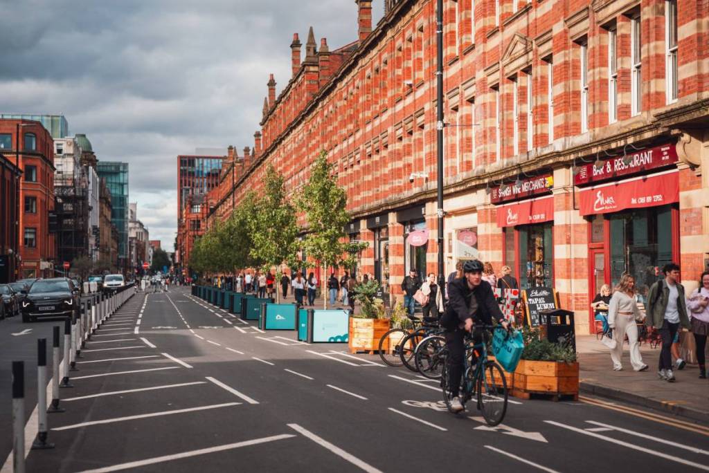 manchester deansgate with rows of sweet gum trees in planters