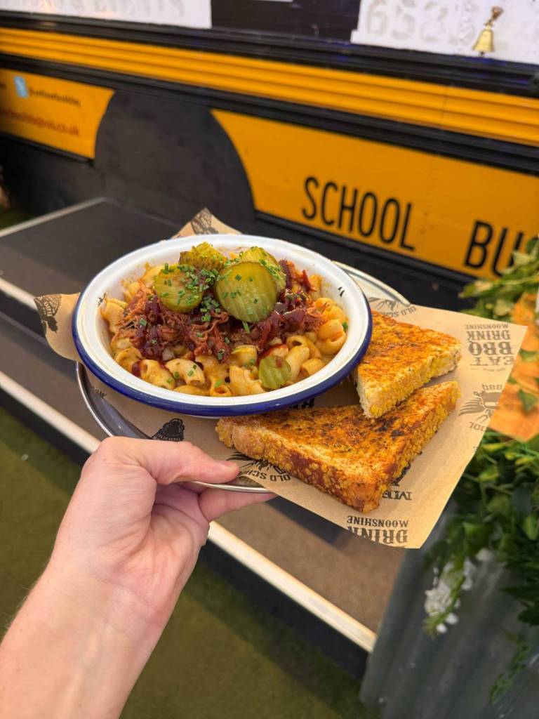 loaded macaroni cheese in front of old school bbq bus