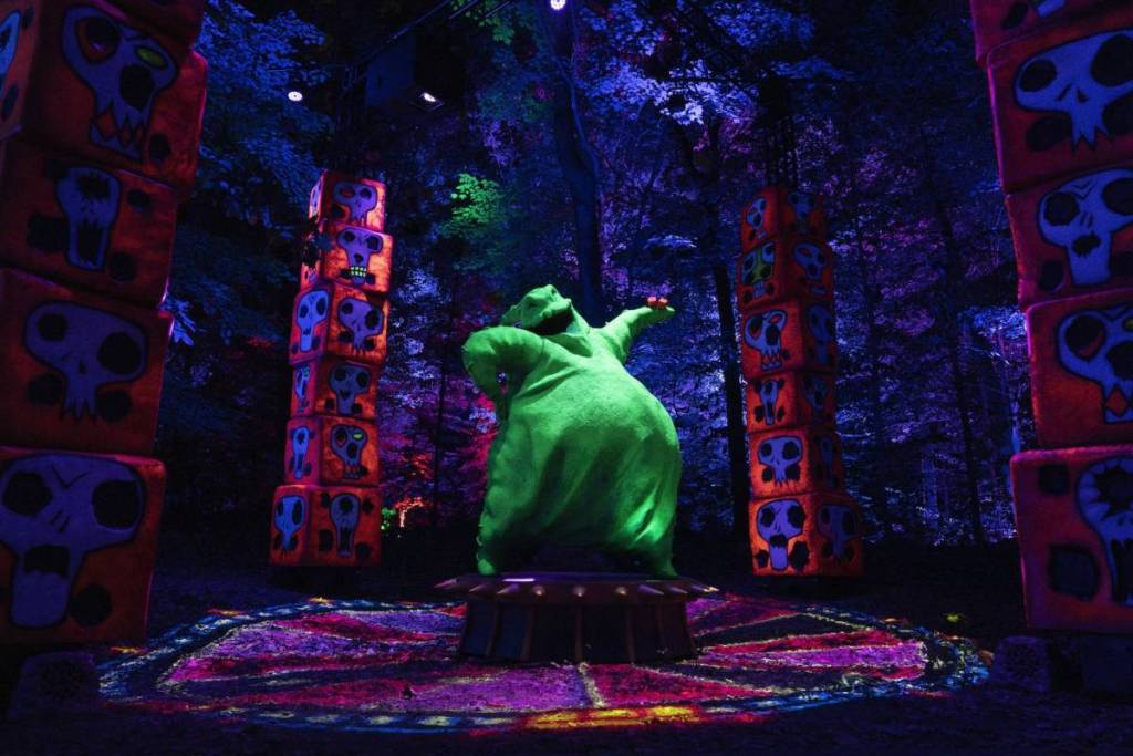 a neon green light installation of Oogie Boogie posing flamboyantly from Disney Tim Burton's The Nightmare Before Christmas light trail
