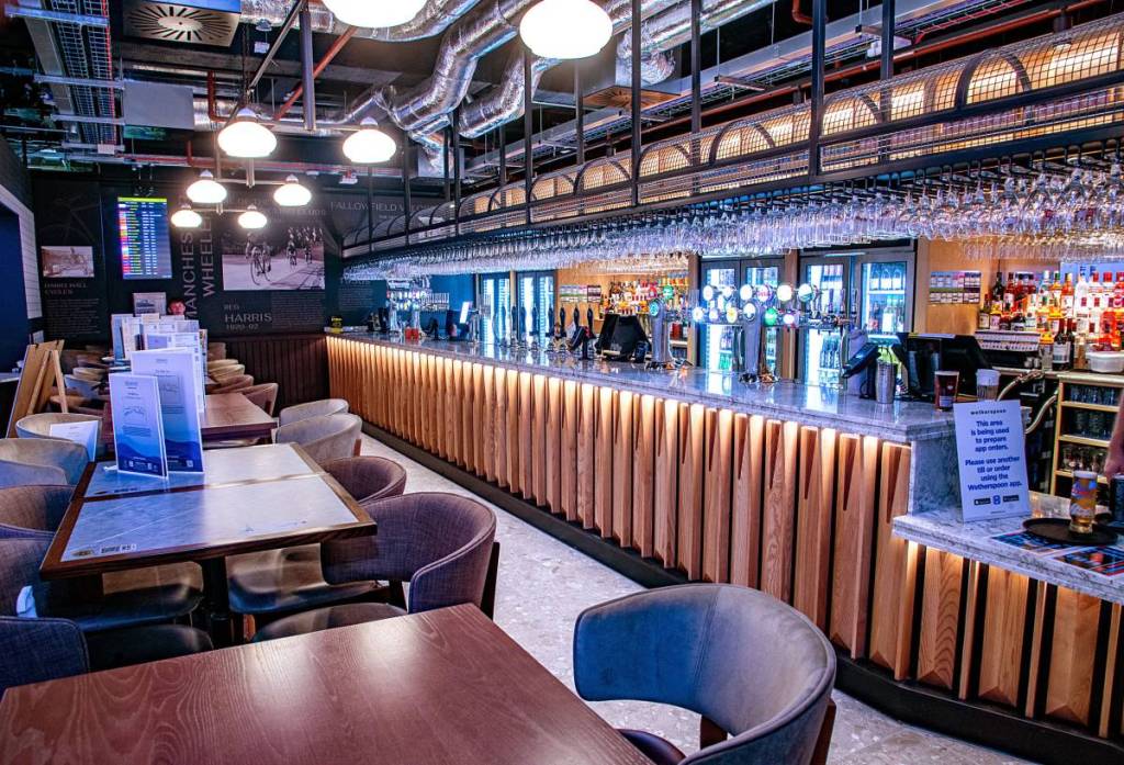bar area and seating at wetherspoons pub in manchester airport, the belle vue