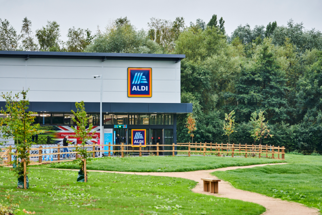 outside aldi store with grass and fence and path around supermarket