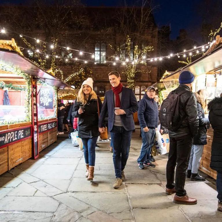 couple walking through christmas markets