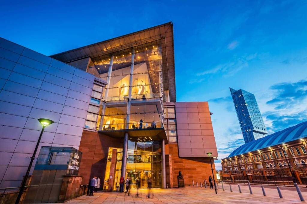 outside bridgewater hall in manchester at night with lights on inside