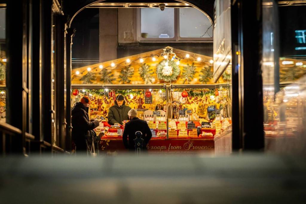 view of manchester christmas markets on king street through archway