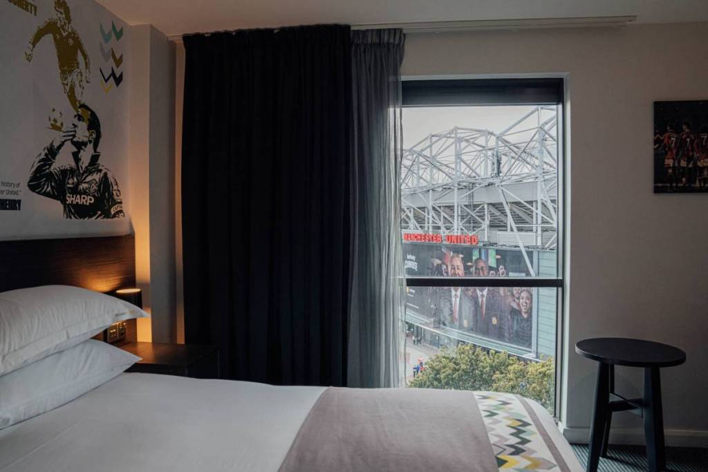 bed at hotel footbal with view from window looking towards old trafford manchester united stadium