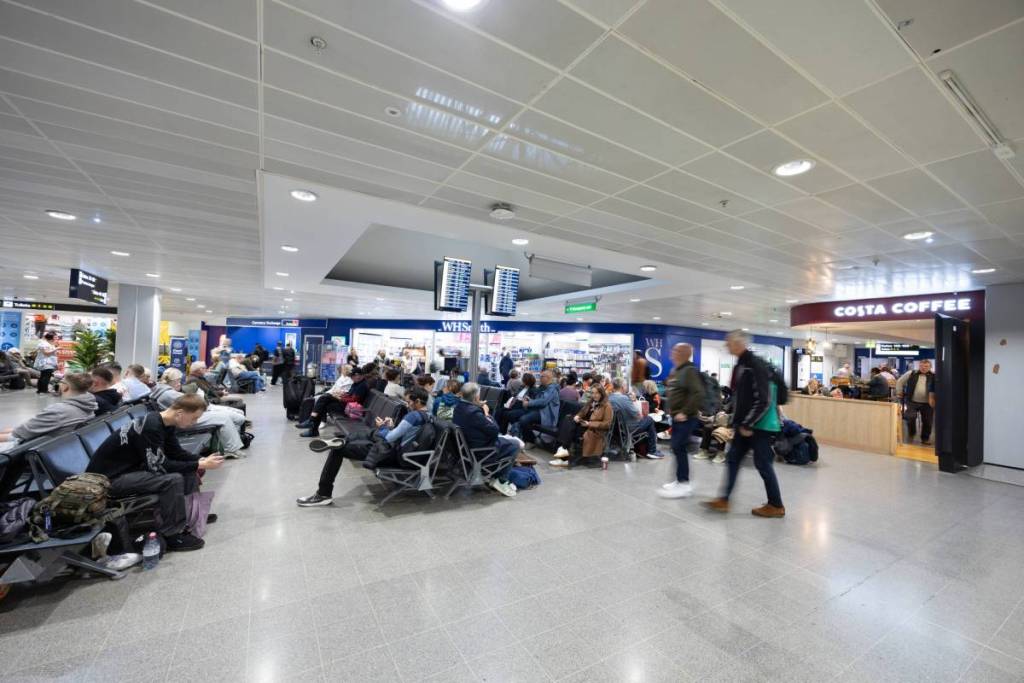 busy terminal 3 departure lounge at manchester airport
