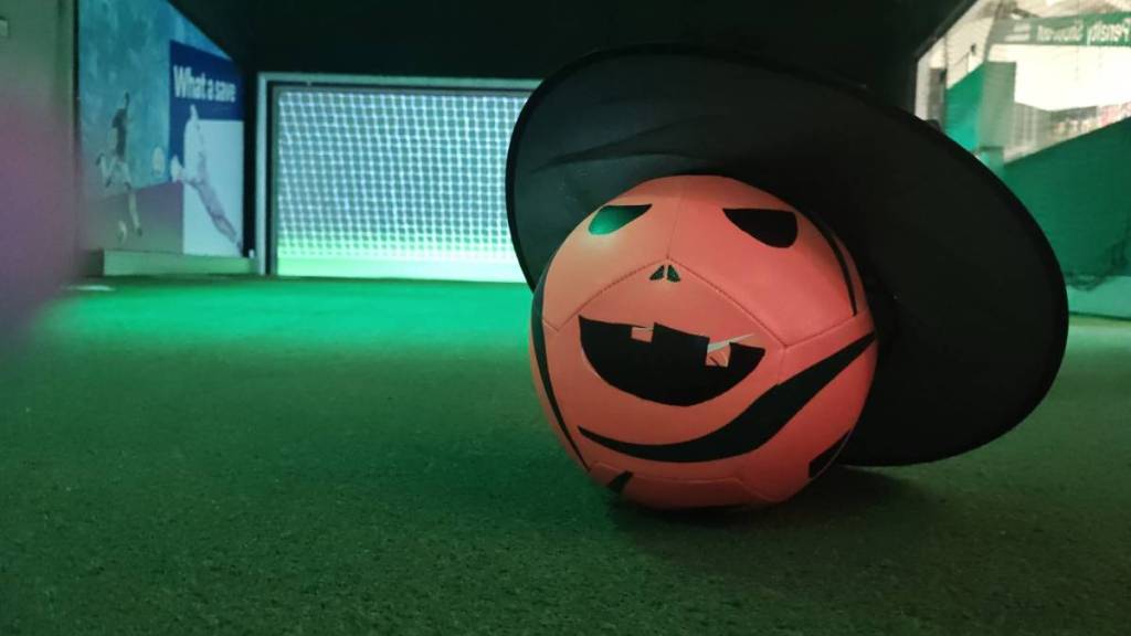football with withces hat on and pumpkincarved face