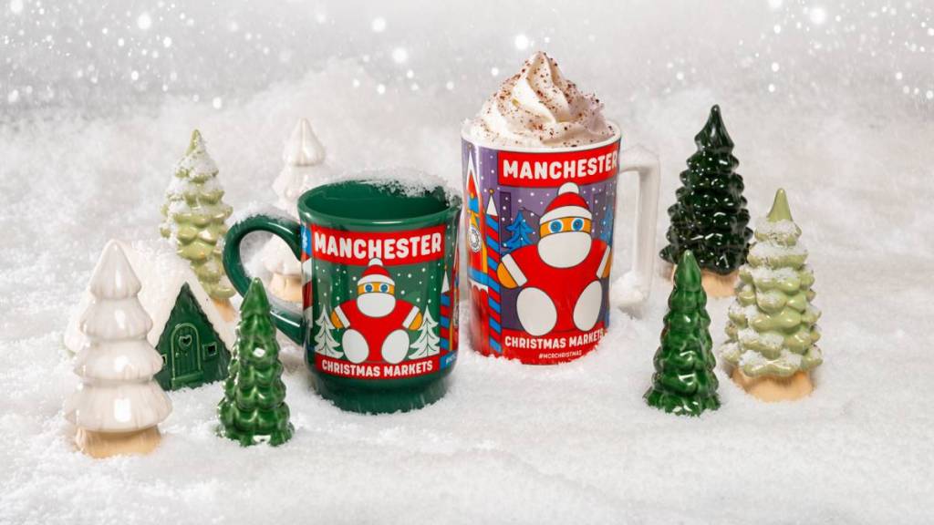 manchester christmas market mugs with giant santa on with one mug topped with whipped cream