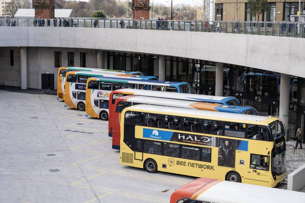 rows of bee network buses at stands at stockport interchange