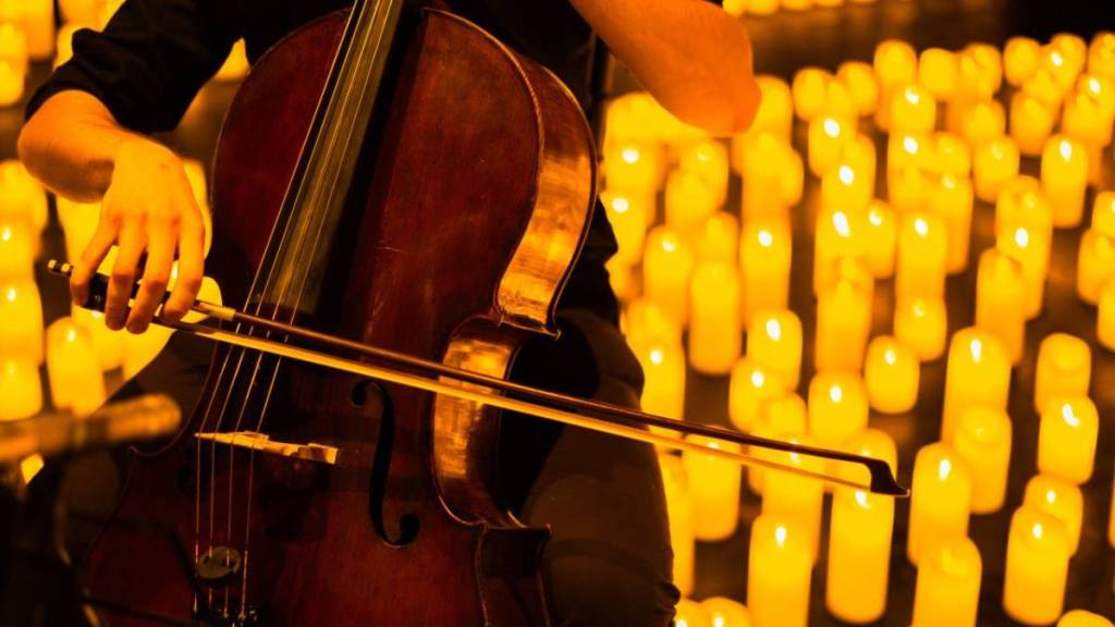 a musicians plays the violin during a candlelight concert