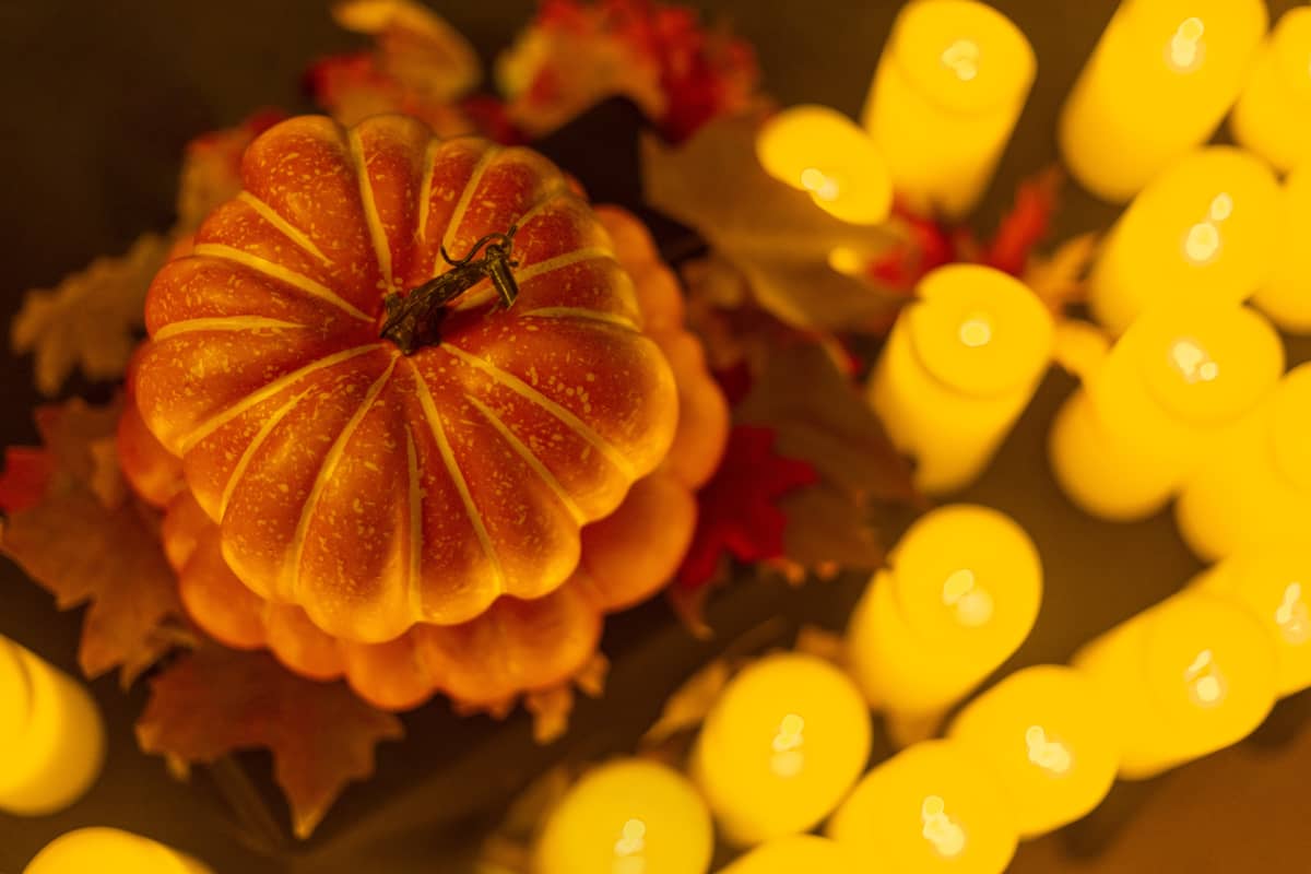 A pumpkin amongst candles at a Candlelight Halloween concert.