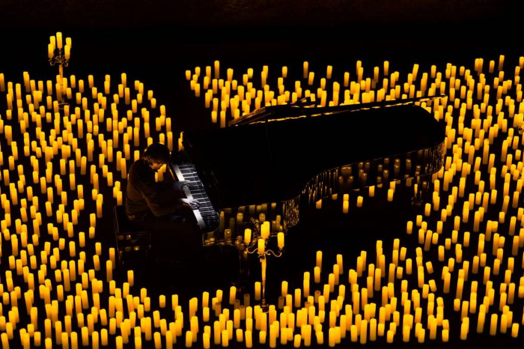 A pianist on stage with candles