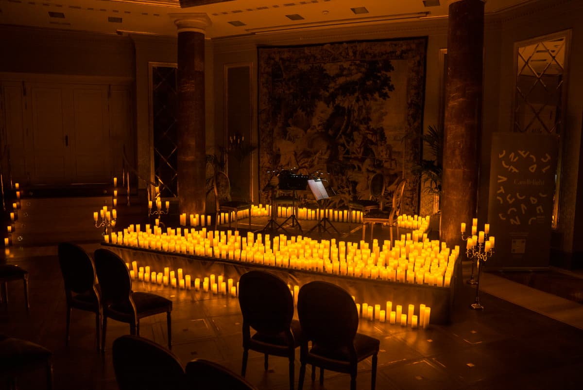 stage lies empty but is filled with candles ready for a concert for occur