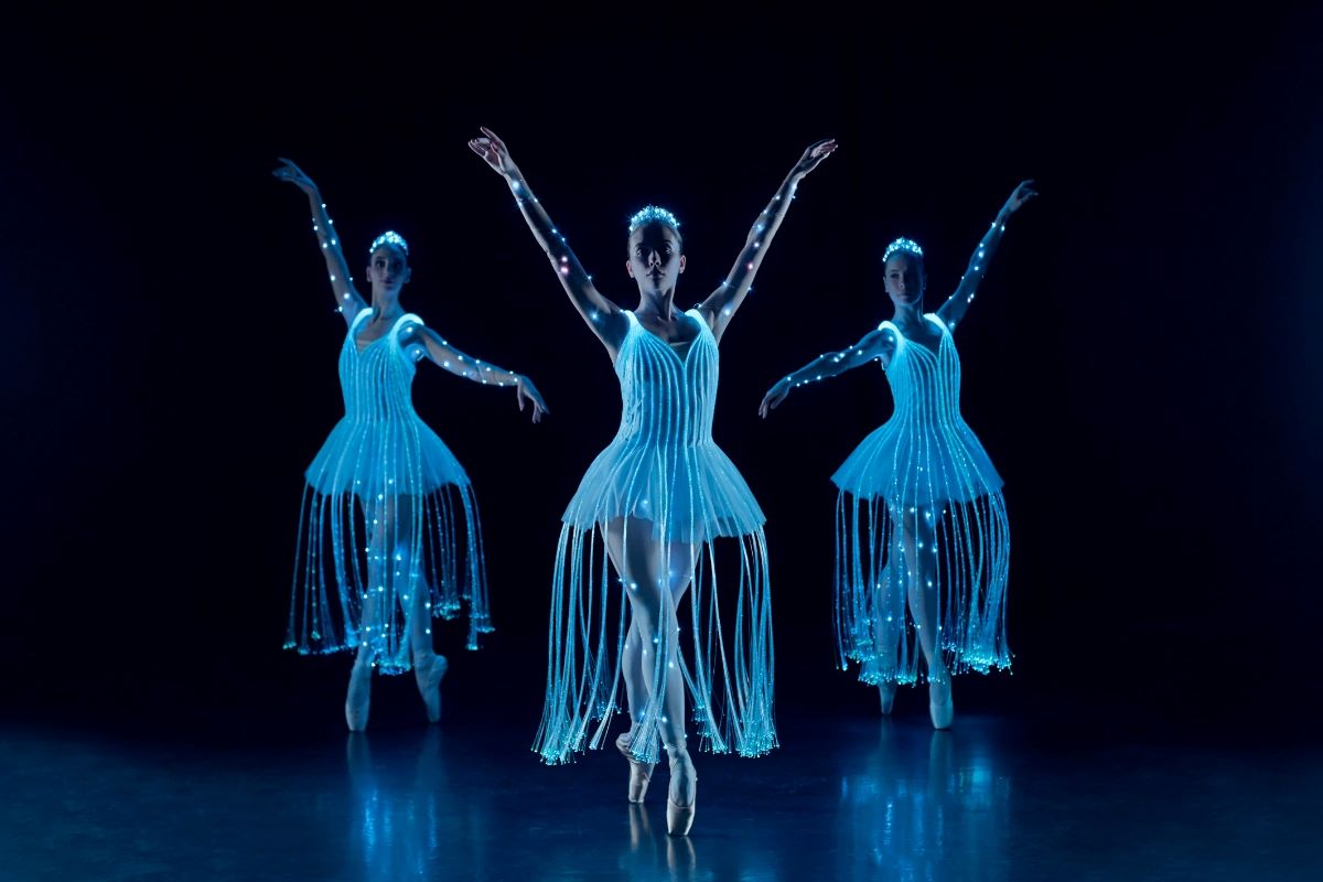 three dancers where glow in the dark costumes as part of WCIB