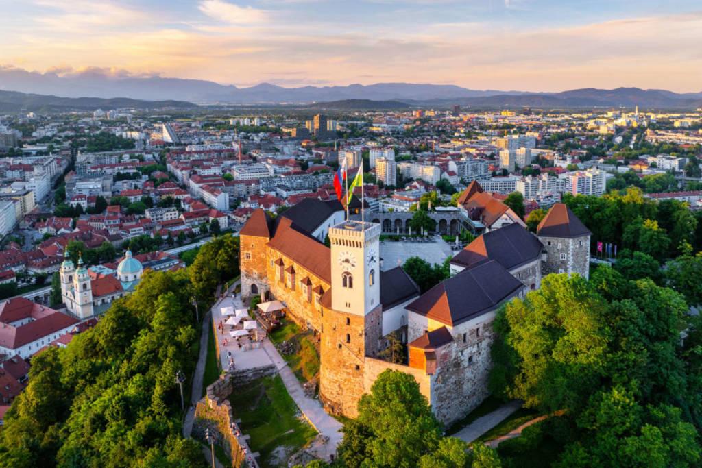 Ljubljana Castle in Slovenia - a large castle surrounded by trees.