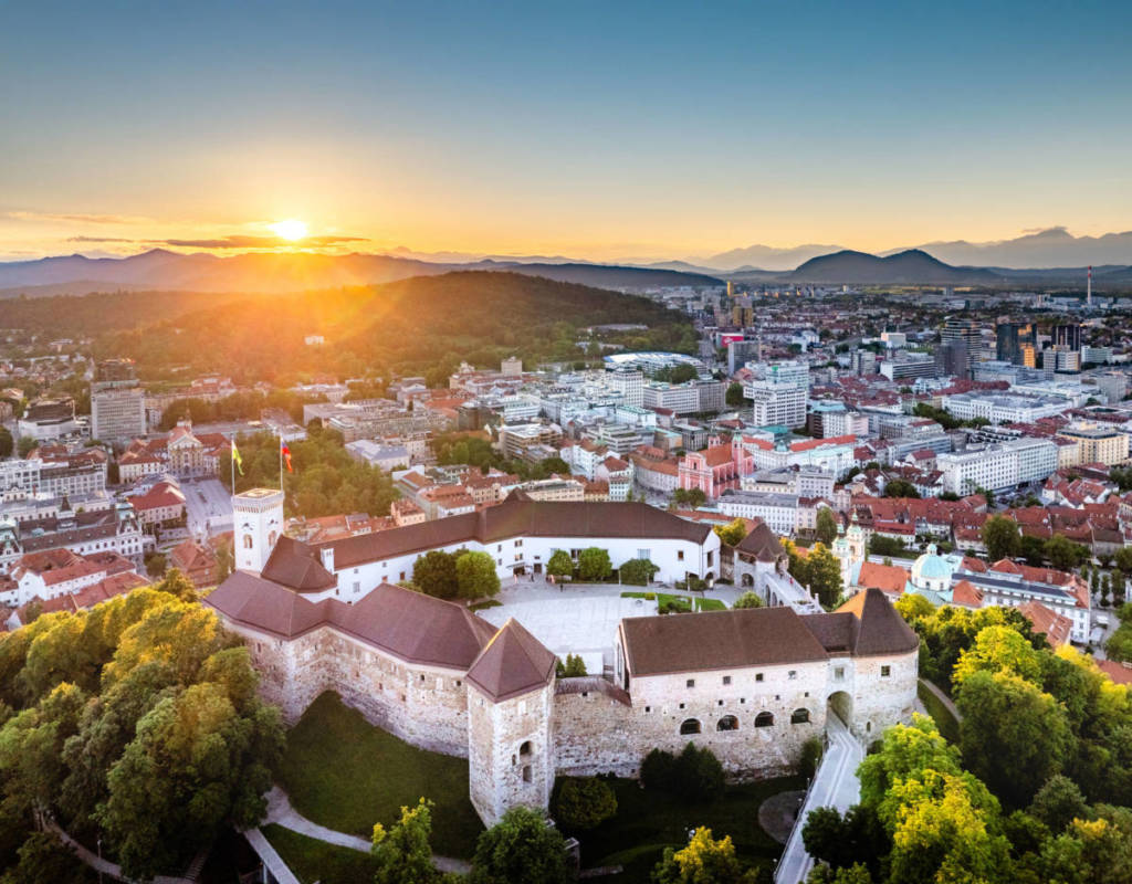 Ljubljana Castle in Slovenia - a large castle surrounded by trees.