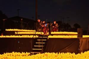 Illuminated drones fly over a string quartet
